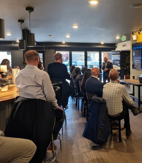 A packed room listening to a presentation at Business Boost