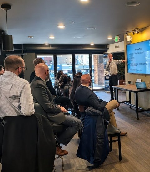 Business owners watching a speaker's slides at Business Boost
