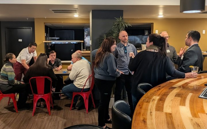 Colorado Springs business owners mingling and talking at an NIA networking event
