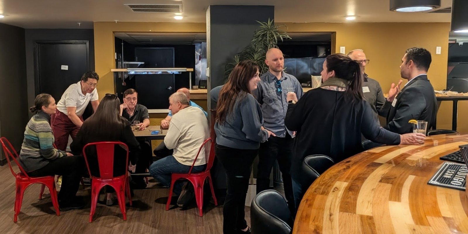 Colorado Springs business owners mingling and talking at an NIA networking event