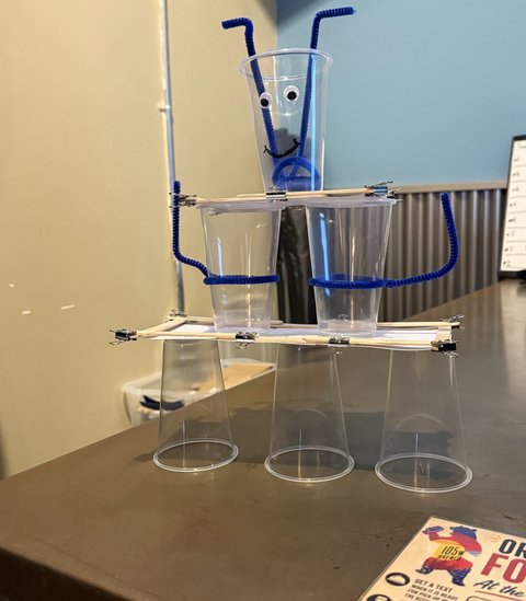 A googly-eyed tower of plastic cups and pipe cleaners