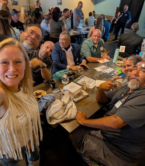 A guest grabbing a selfie with a grinning table