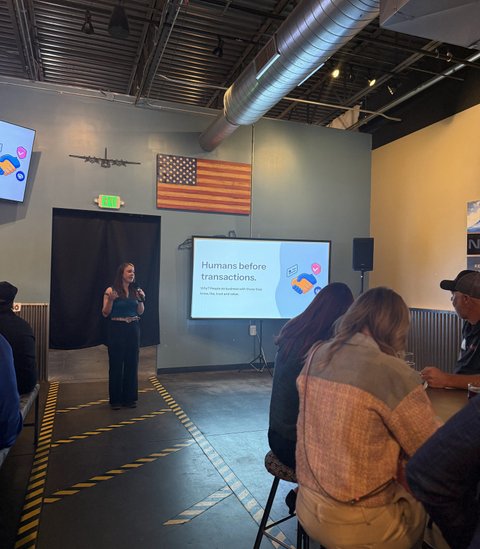 Heather Blasnek presenting a slide that reads Humans before transactions