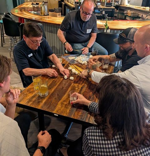 A table of members starting their marshmallow build together