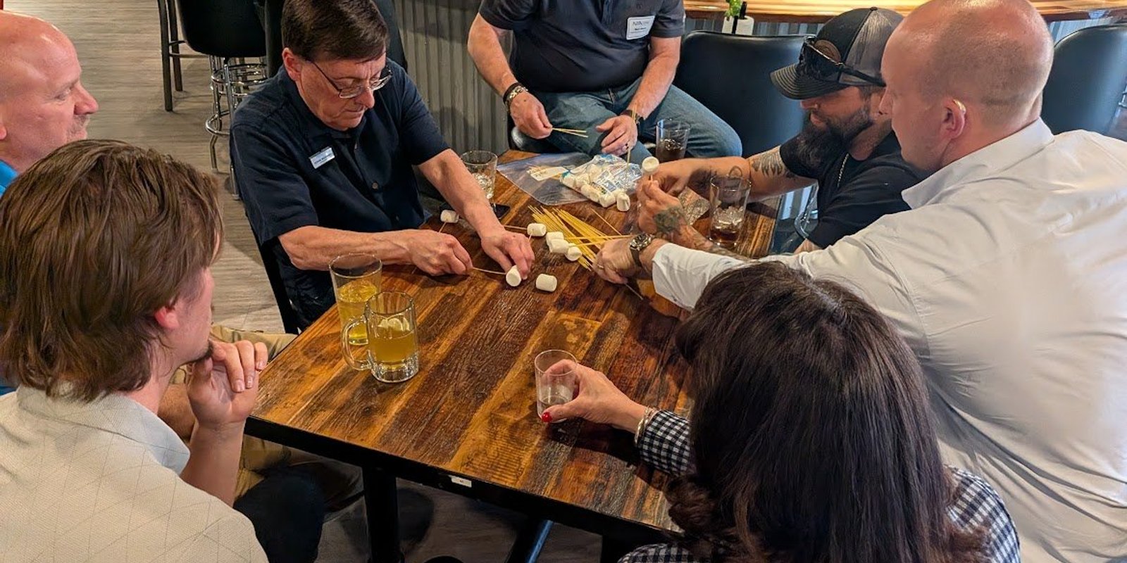 NIA Colorado Springs members talking across a table at a monthly member meeting