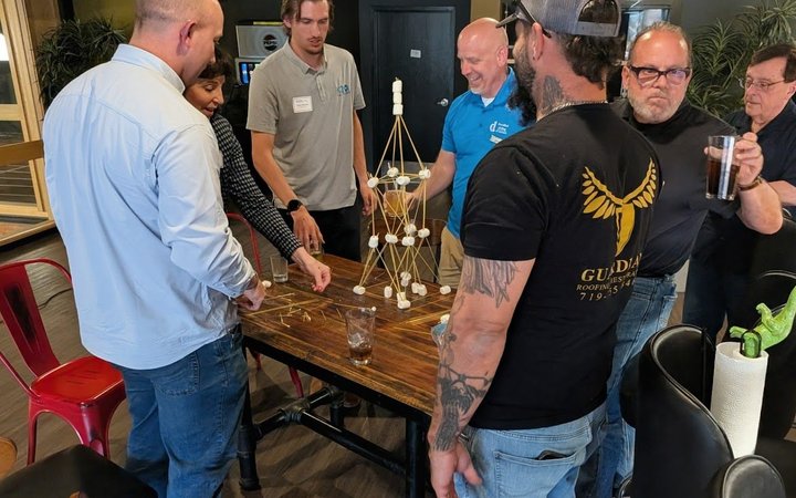 NIA members working together on a team building activity at a member meeting