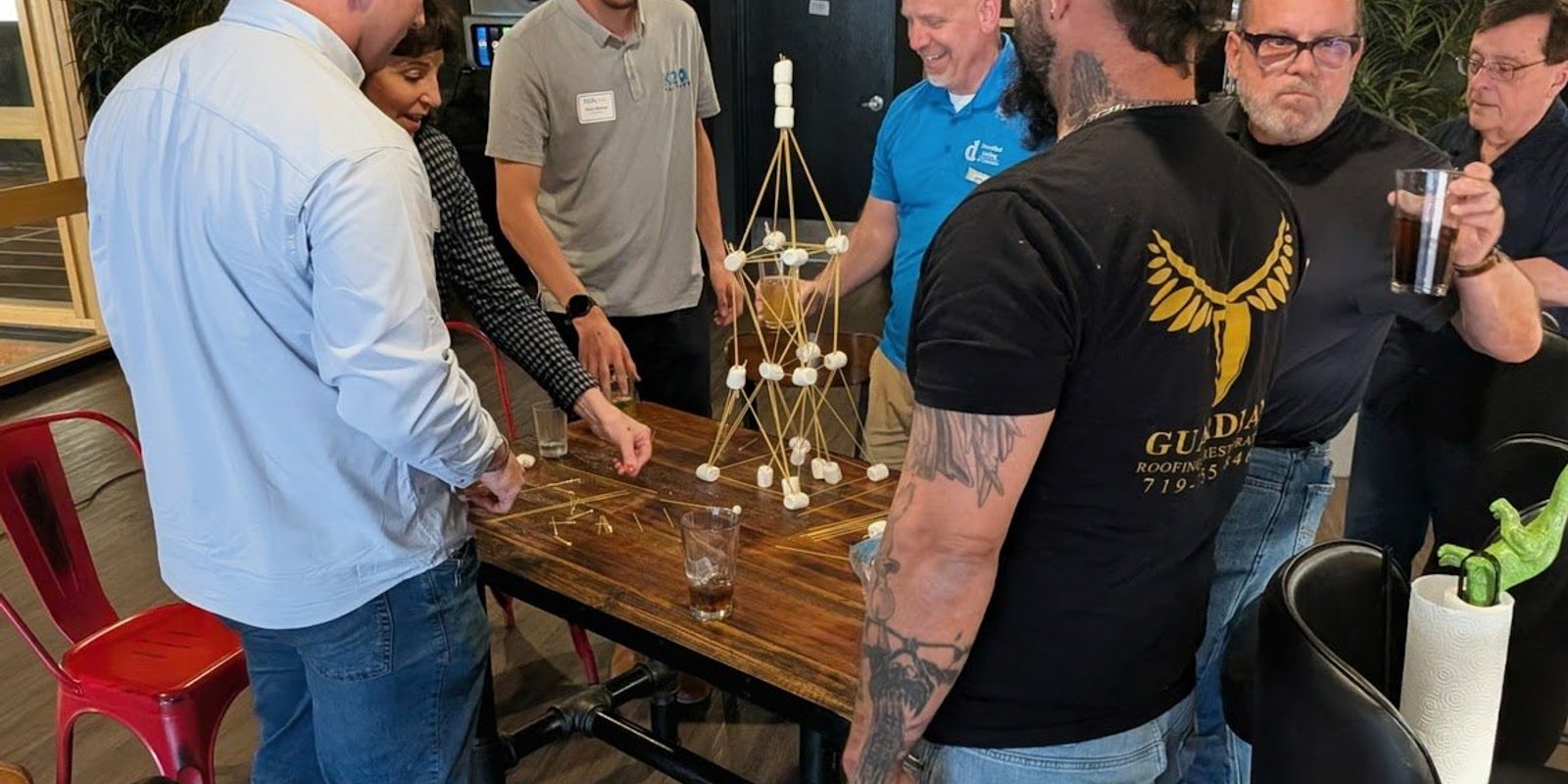 NIA members working together on a team building activity at a member meeting