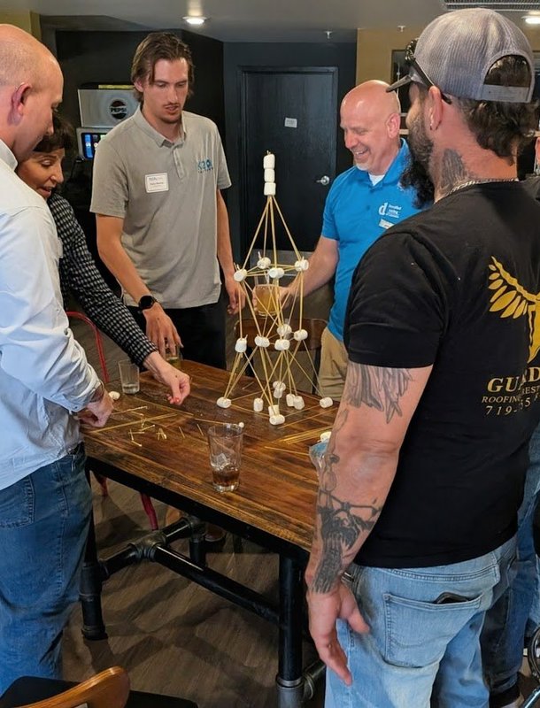 Members laughing over a team building challenge