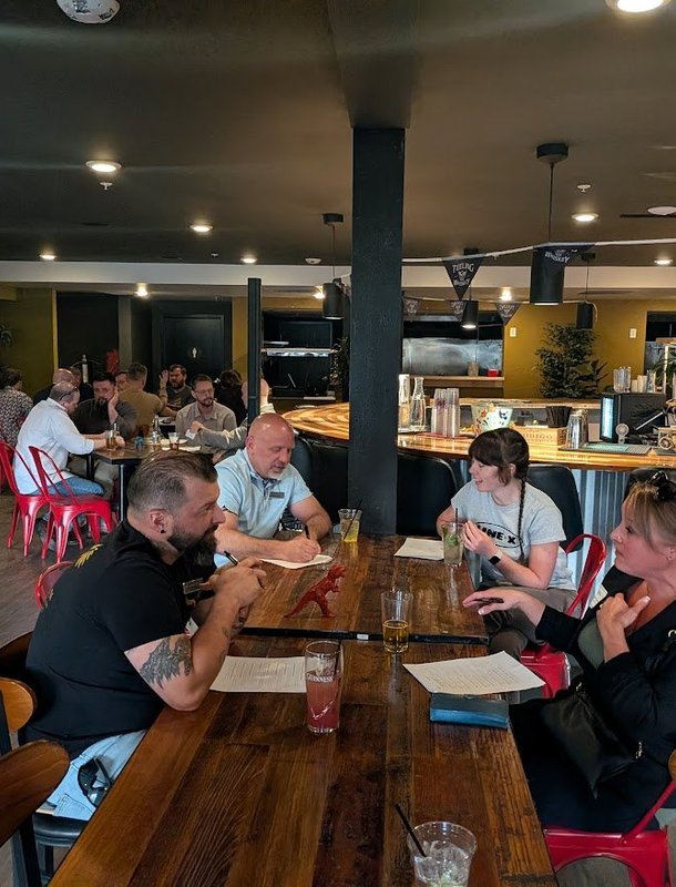 Members at a brewery table during an NIA meeting