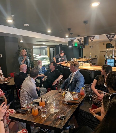 Smiling members at a table during a monthly meeting