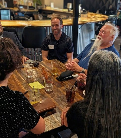 Members deep in conversation around a table