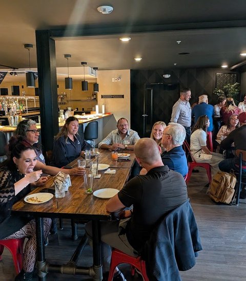 Members sharing lunch and conversation at a table