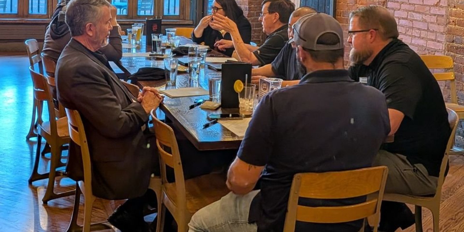 NIA Colorado Springs members gathered around a table at a member meeting